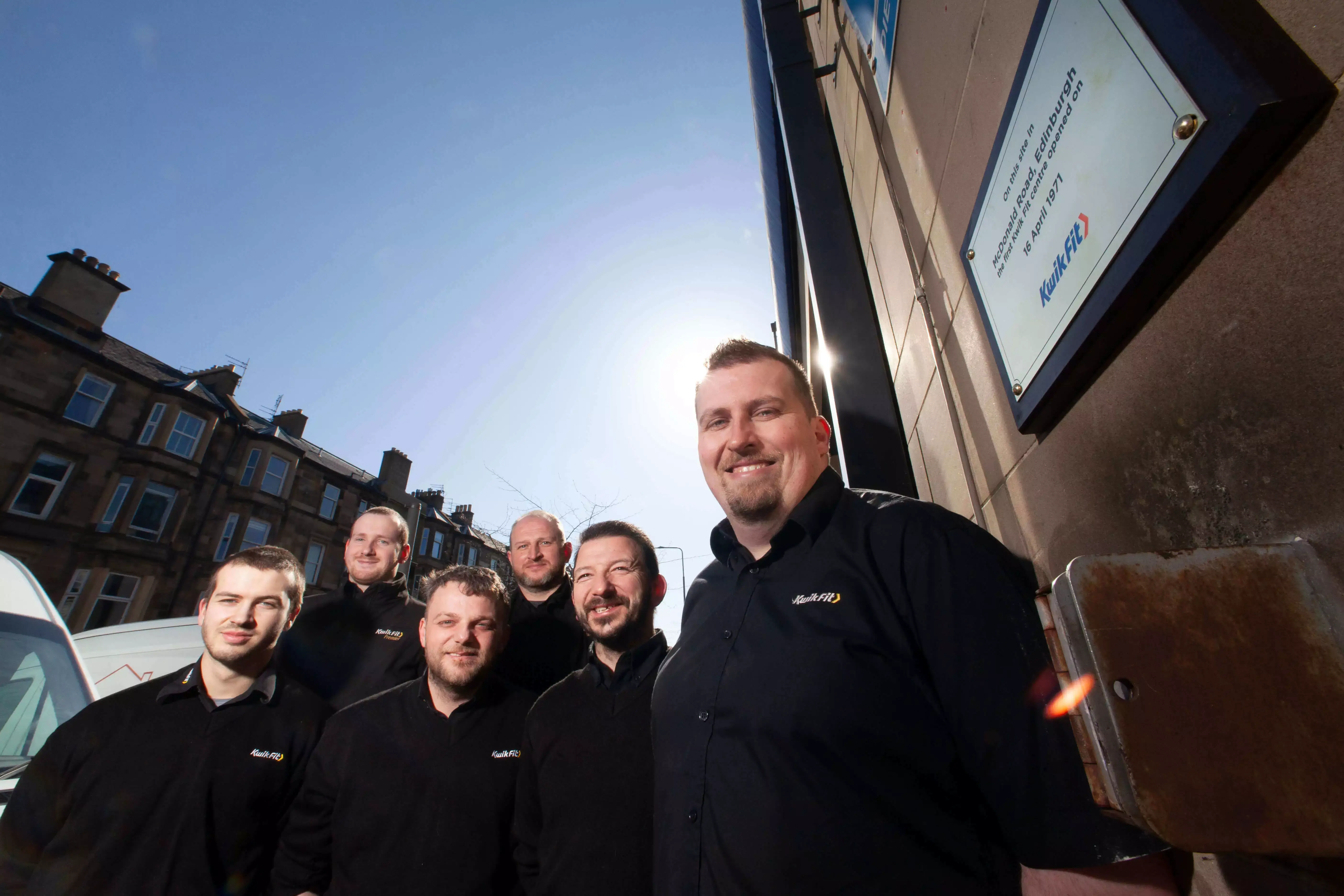 Kwik Fit centre employees posing outside the Mcdonalds Road, Edinburgh centre.